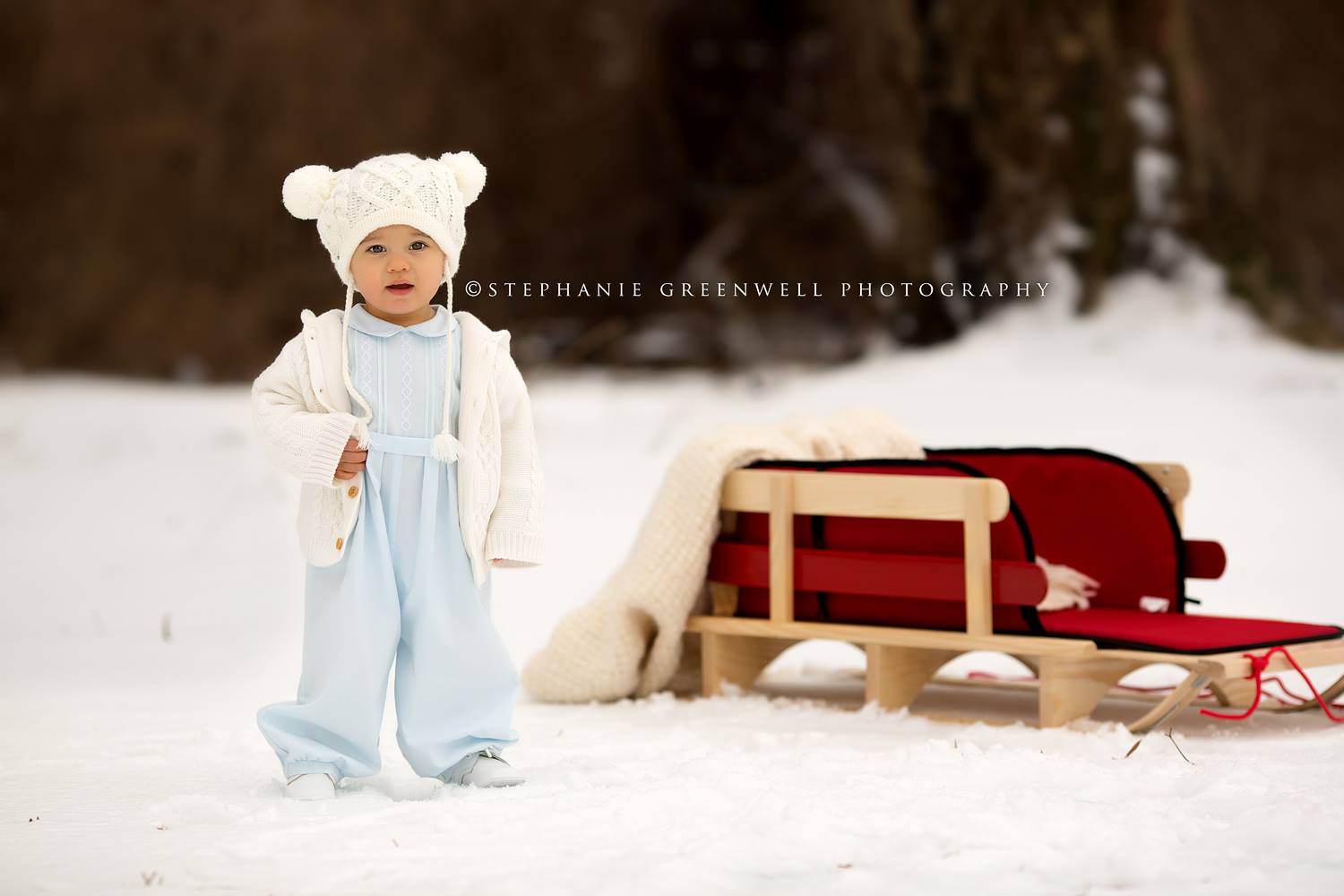 baby in snow field sled forest handmade hat southeast missouri photographer stephanie greenwell