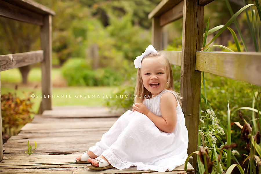 little girl in white dress on wooden bridge jackson tennessee stephanie greenwell