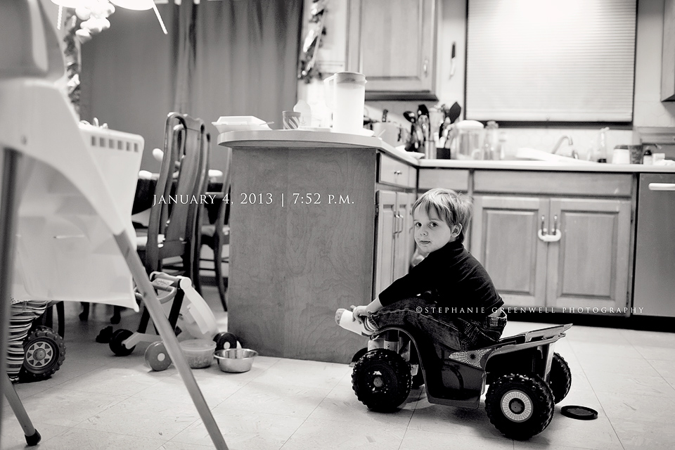 photo-a-day january boy in kitchen riding 4-wheeler stephanie greenwell