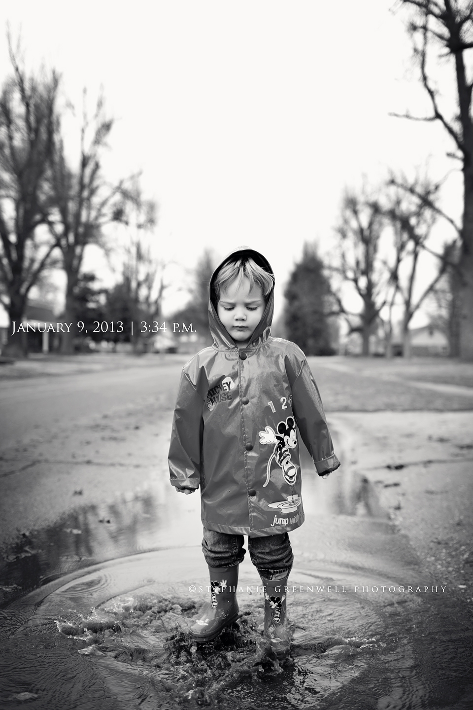 boy jumping in puddle rain coat rain boots stephanie greenwell