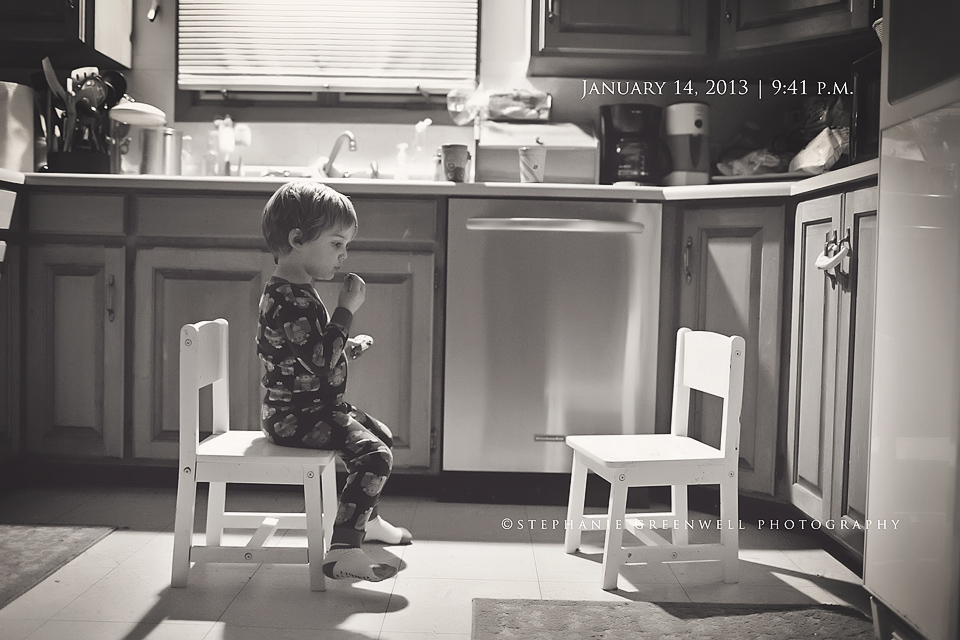 little boy eating cookies and milk sitting in kitchen stephanie greenwell photography