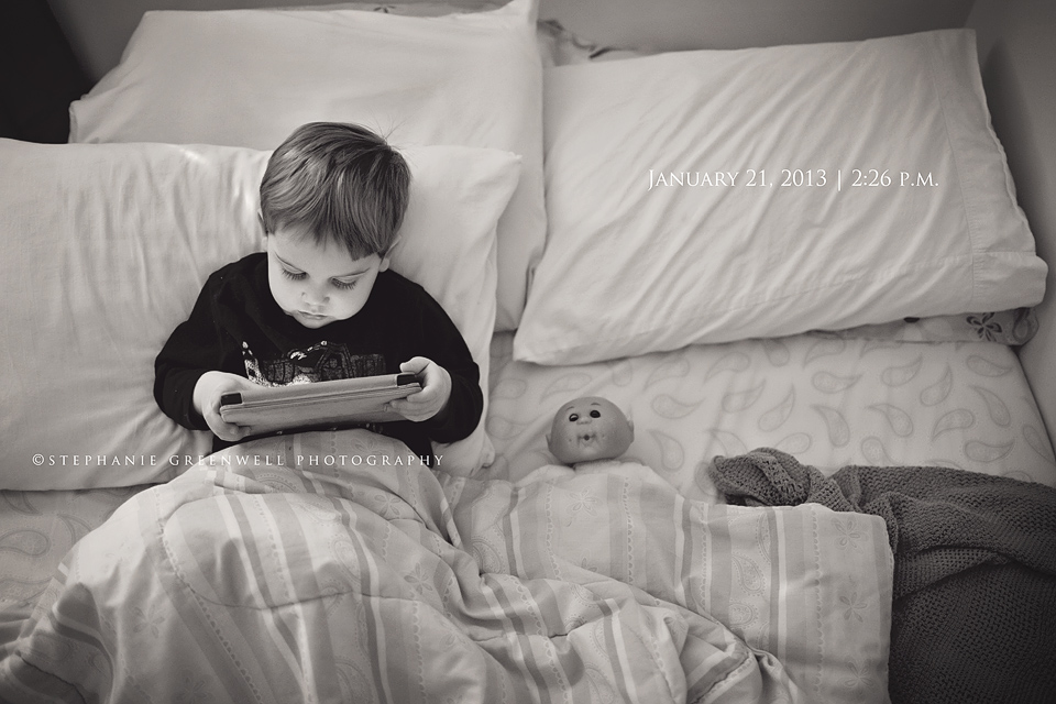 boy in bed with baby doll kindle photo-a-day stephanie greenwell