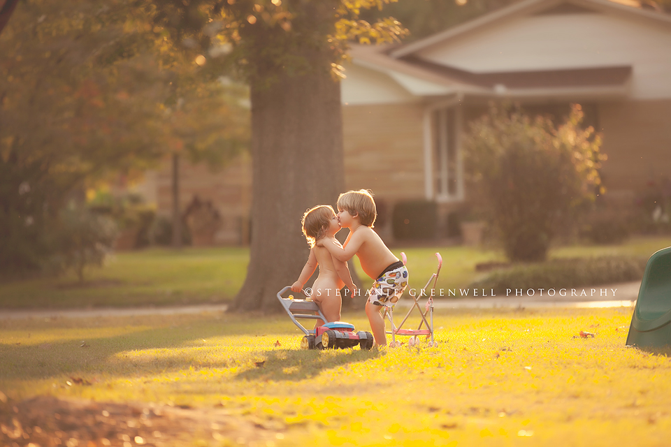 cooper harper kissing siblings sunlight lawn mower stroller stephanie greenwell photography