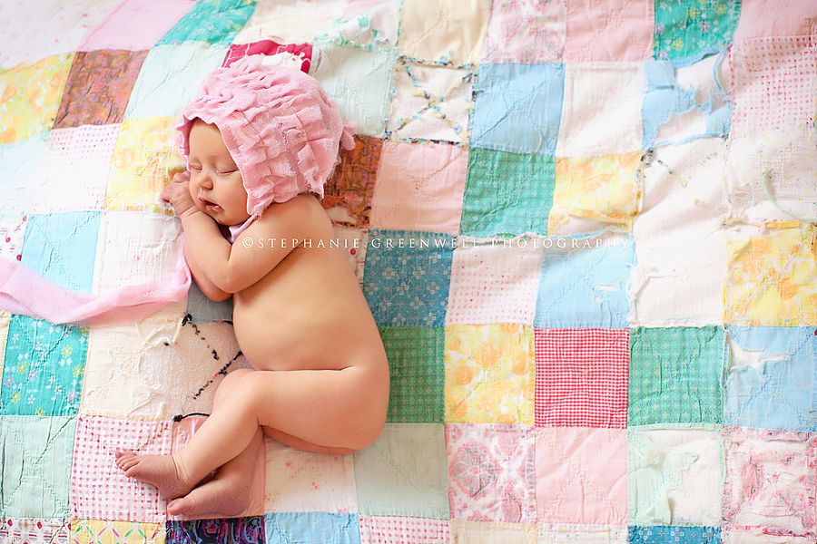 newborn baby pink bonnet lying on quilt stephanie greenwell missouri